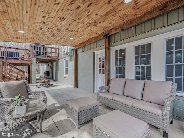 view of patio / terrace featuring stairway and an outdoor living space with a fire pit