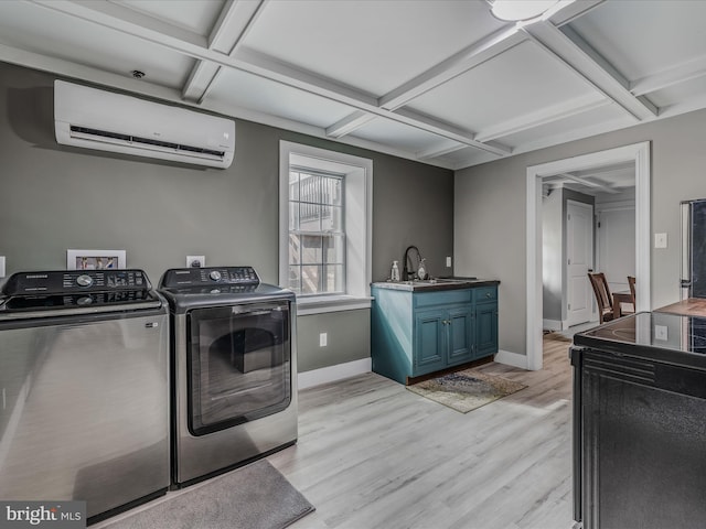 laundry room with washing machine and dryer, light wood-style flooring, a sink, baseboards, and an AC wall unit