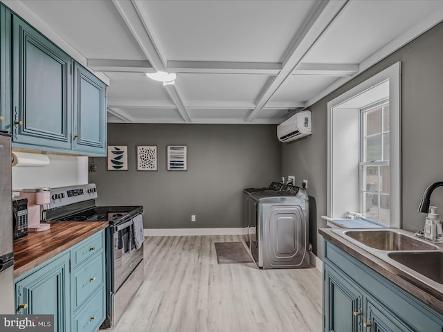 kitchen with a wall unit AC, butcher block counters, blue cabinets, stainless steel electric stove, and washer and dryer