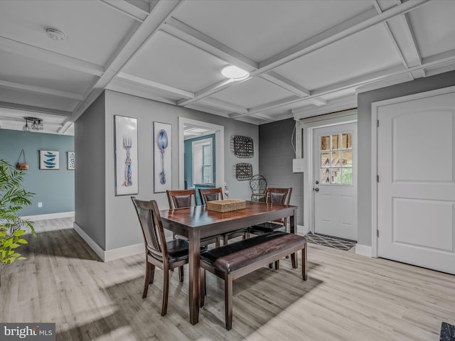 dining space with beam ceiling, coffered ceiling, light wood-style flooring, and baseboards