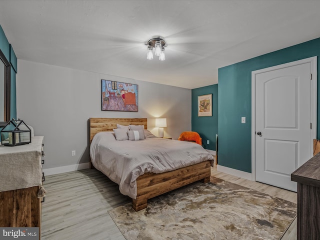 bedroom featuring light wood-style flooring and baseboards