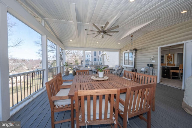 sunroom featuring lofted ceiling, ceiling fan, and wood ceiling