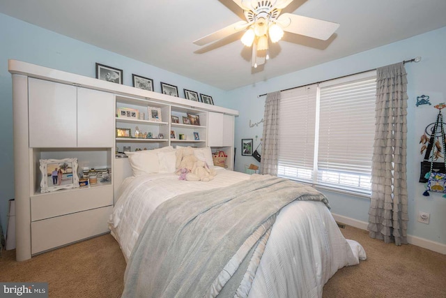 bedroom featuring baseboards, a ceiling fan, and light colored carpet