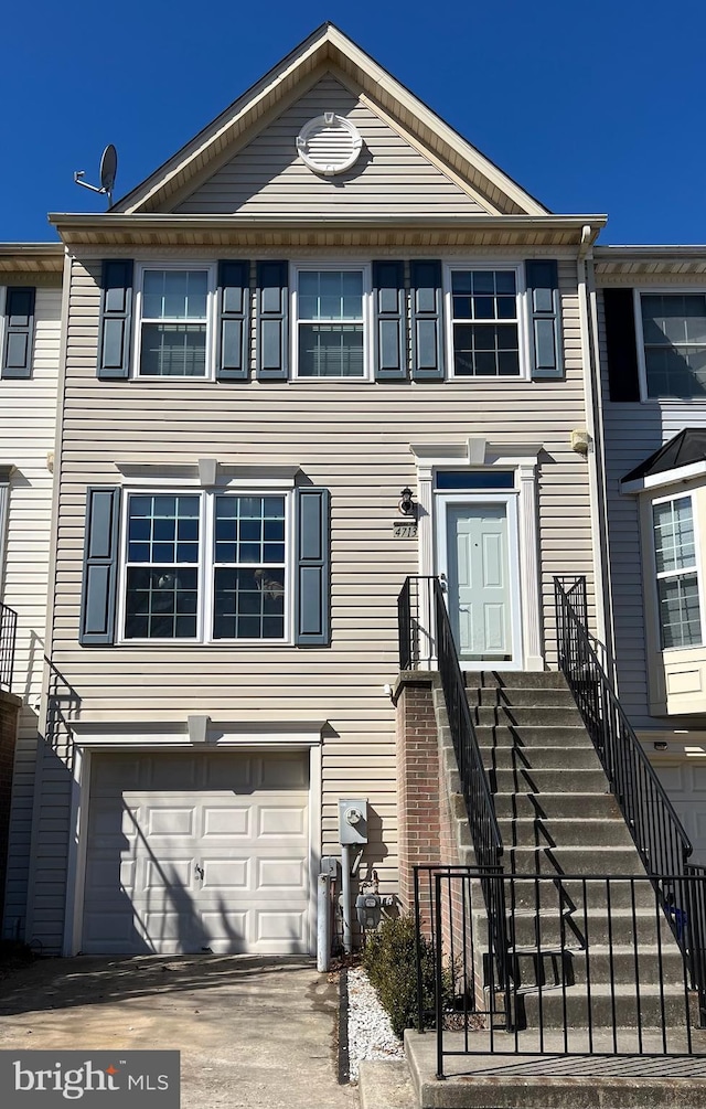 view of property featuring an attached garage and driveway