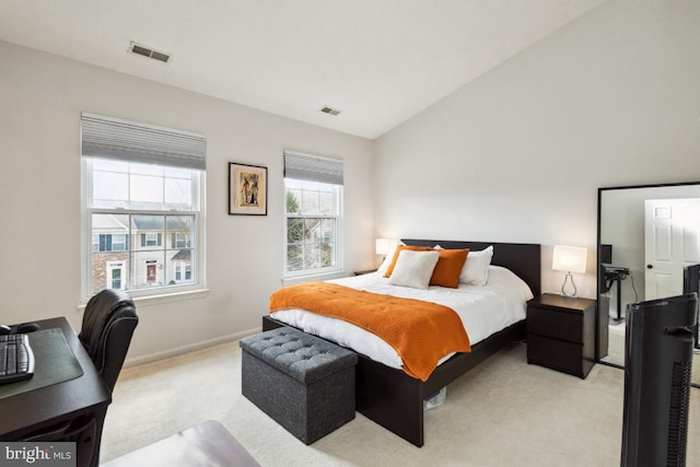 bedroom with light carpet, visible vents, baseboards, and vaulted ceiling