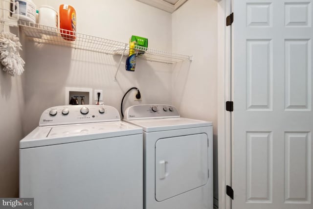 clothes washing area with washing machine and clothes dryer and laundry area