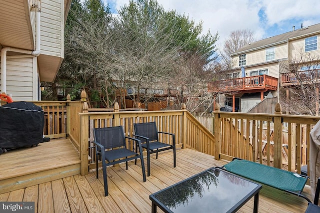 wooden deck with a grill