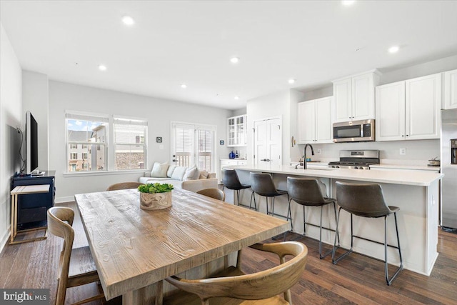 dining area with dark wood finished floors and recessed lighting