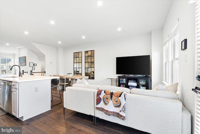 living room with recessed lighting and dark wood-style flooring