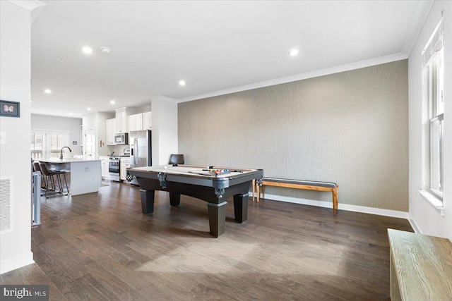 rec room featuring a sink, baseboards, dark wood-type flooring, and ornamental molding