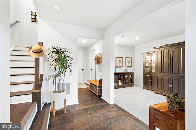 foyer entrance featuring visible vents, wood finished floors, recessed lighting, baseboards, and stairs