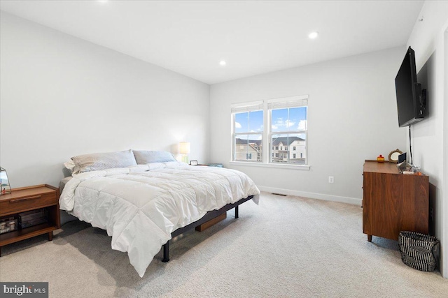 bedroom with recessed lighting, baseboards, light carpet, and visible vents