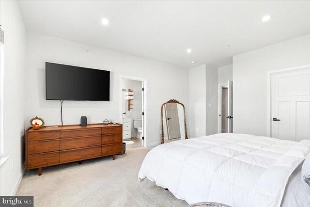 bedroom with recessed lighting, baseboards, light carpet, and ensuite bathroom