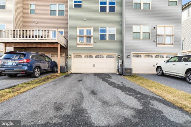 exterior space featuring central AC, a garage, and driveway