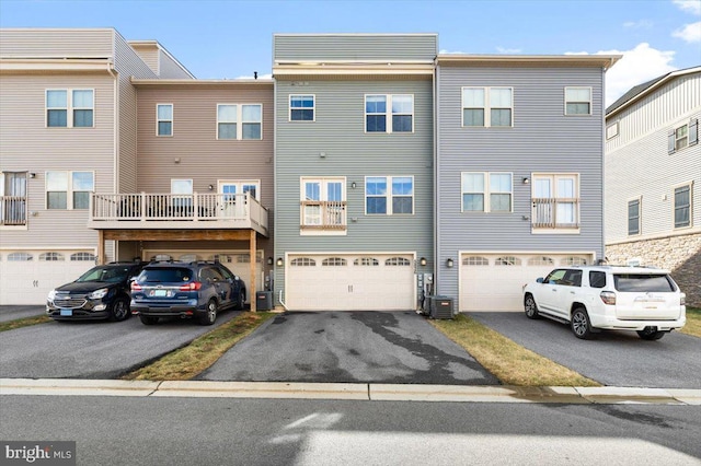 exterior space featuring cooling unit, driveway, and a garage