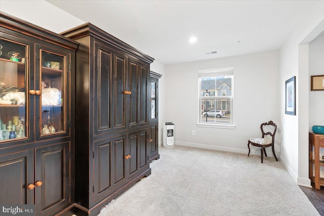 interior space featuring recessed lighting, light colored carpet, visible vents, and baseboards