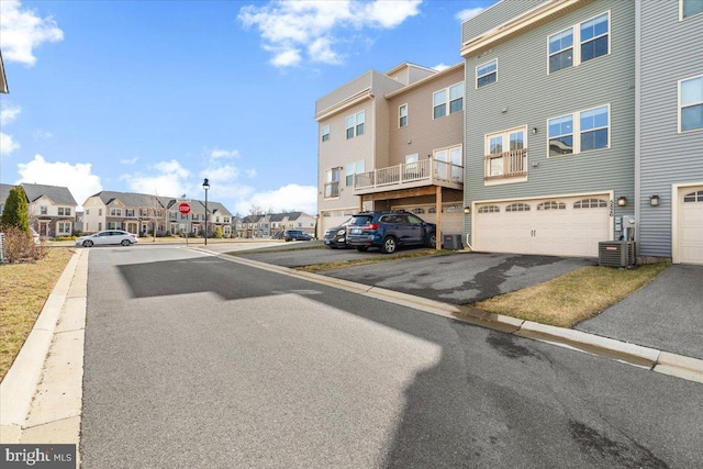 view of road featuring a residential view, curbs, and traffic signs