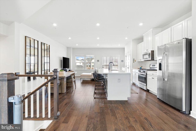 kitchen with dark wood-style floors, recessed lighting, white cabinetry, and stainless steel appliances