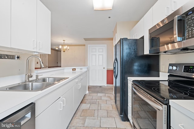 kitchen featuring white cabinets, stainless steel appliances, a sink, and light countertops