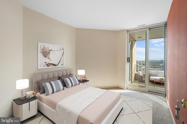 carpeted bedroom with access to outside, expansive windows, visible vents, and baseboards