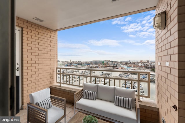 balcony with an outdoor hangout area, a view of city, and visible vents