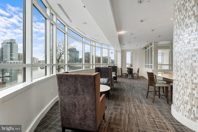 sunroom / solarium featuring a city view