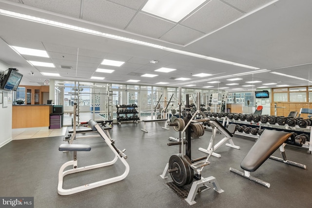 exercise room with a paneled ceiling