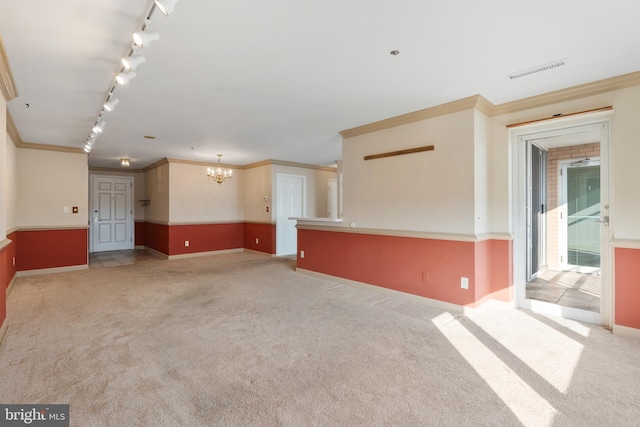 unfurnished room with ornamental molding, carpet, and visible vents