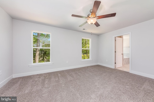 unfurnished room with carpet flooring, a ceiling fan, and baseboards