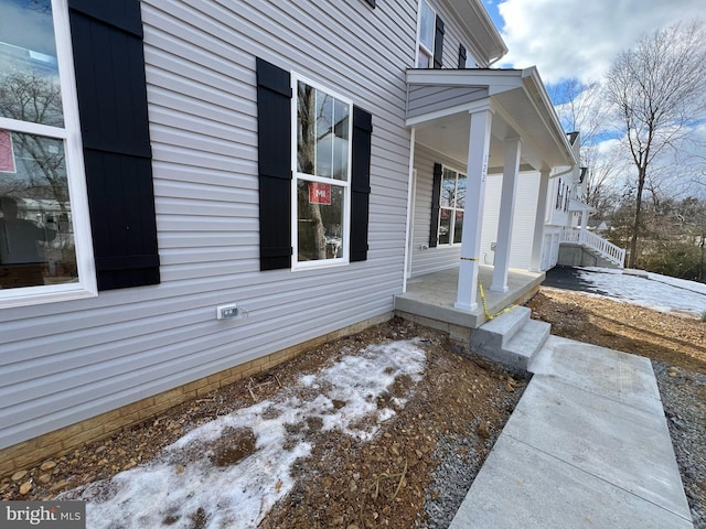 view of property exterior with a porch