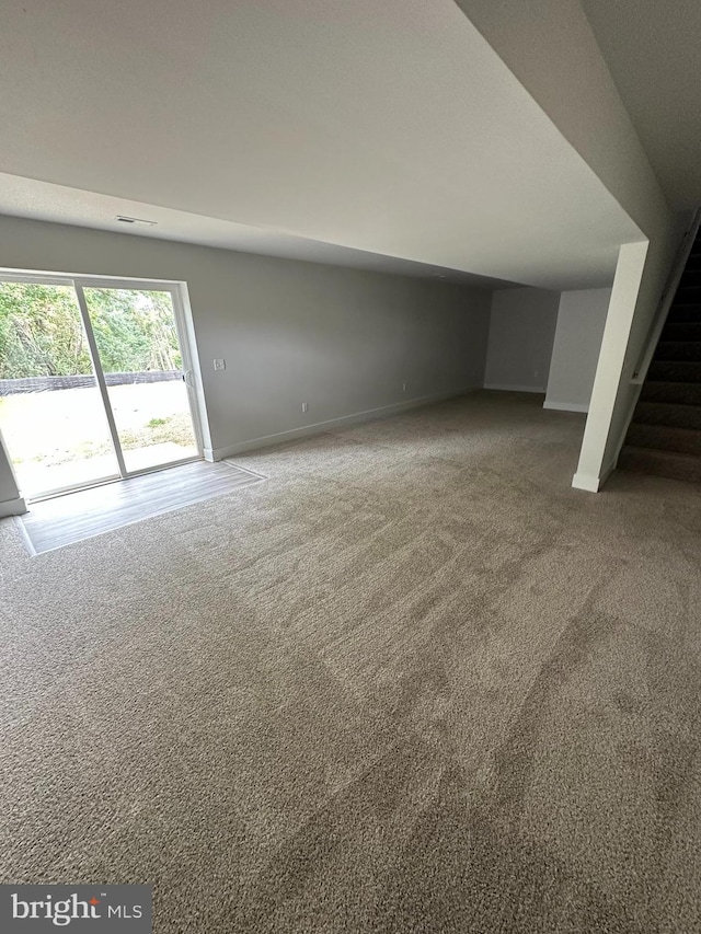 bonus room with stairs, carpet, and baseboards