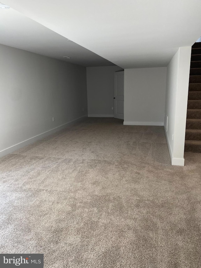 interior space featuring stairs, carpet flooring, and baseboards