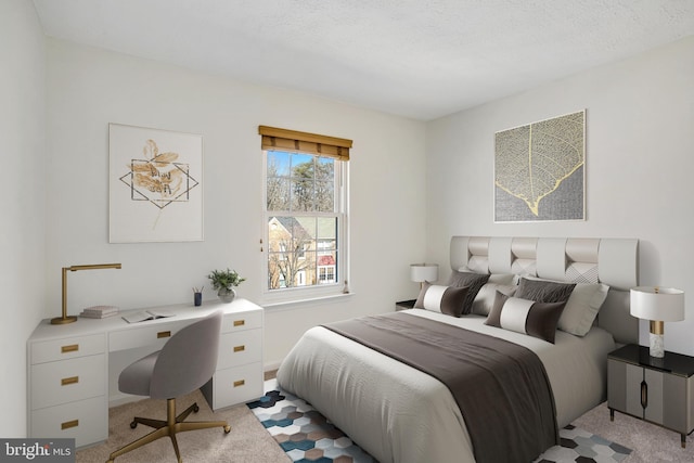 bedroom featuring light carpet and a textured ceiling