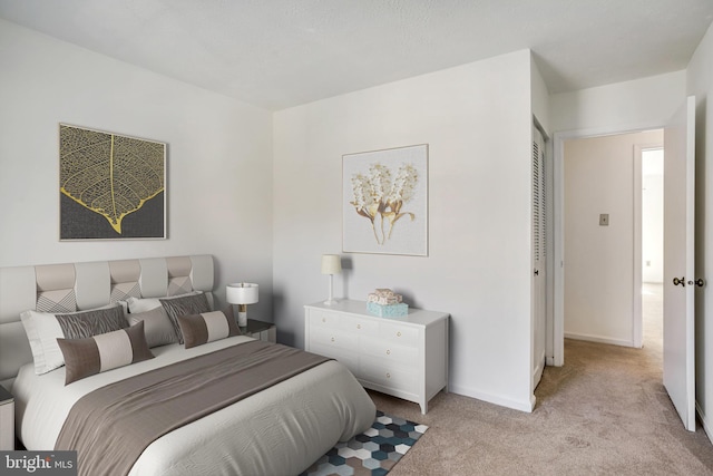 bedroom with carpet flooring and baseboards