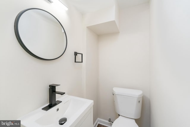 bathroom featuring toilet and a sink