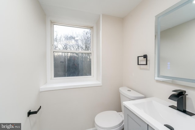 bathroom featuring vanity and toilet