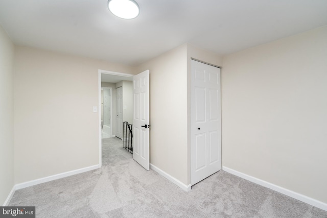 unfurnished bedroom featuring carpet floors and baseboards