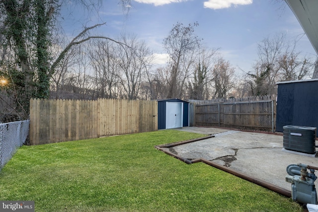 view of yard featuring a patio, a storage unit, central air condition unit, a fenced backyard, and an outdoor structure