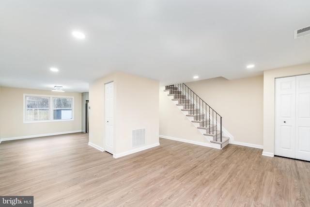 interior space featuring stairs, wood finished floors, visible vents, and baseboards