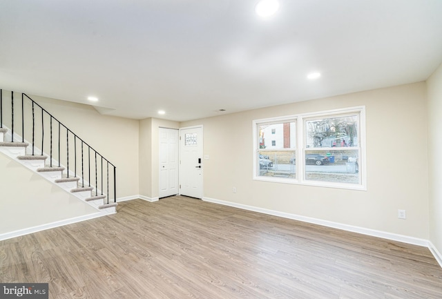 foyer featuring stairs, recessed lighting, wood finished floors, and baseboards