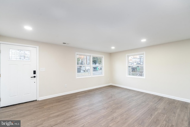 entryway featuring recessed lighting, visible vents, baseboards, and wood finished floors