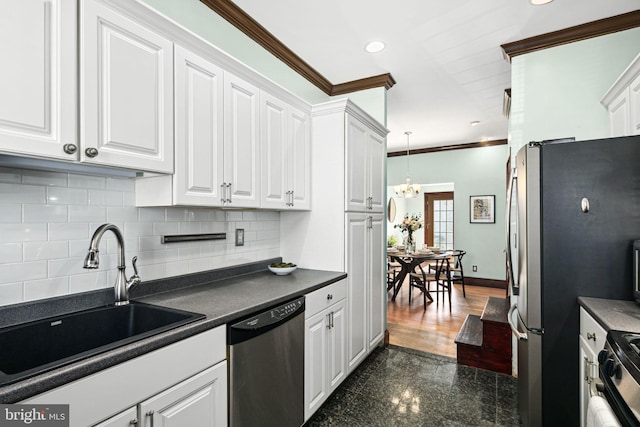 kitchen featuring recessed lighting, granite finish floor, a sink, baseboards, and appliances with stainless steel finishes