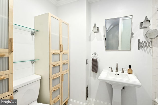 bathroom with toilet and baseboards