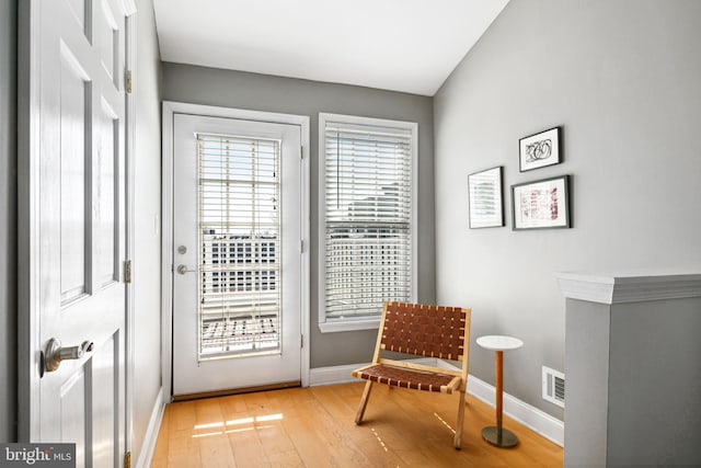 sitting room featuring light wood-style floors, baseboards, and visible vents