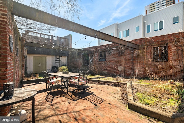 view of patio / terrace featuring stairway and outdoor dining area