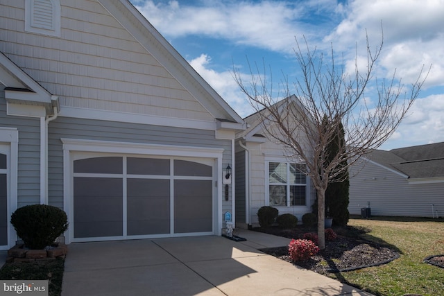 view of front of home with an attached garage and concrete driveway