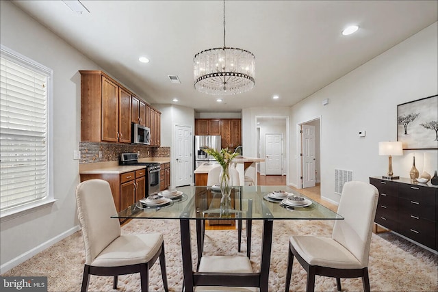 dining area with baseboards, recessed lighting, visible vents, and an inviting chandelier