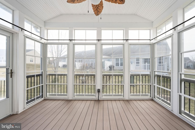 unfurnished sunroom with lofted ceiling and ceiling fan