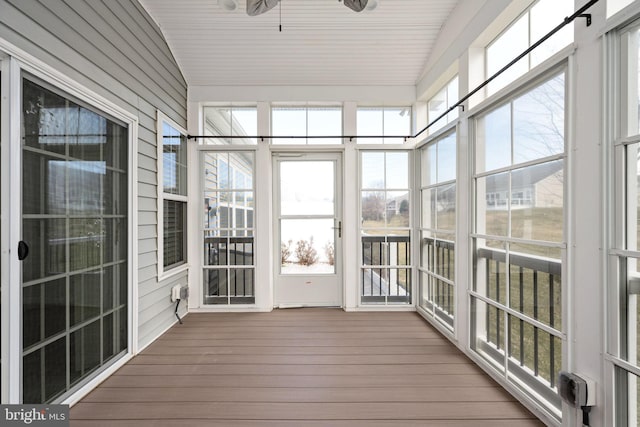 unfurnished sunroom featuring a ceiling fan