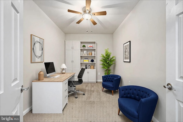 home office with light carpet, baseboards, and a ceiling fan